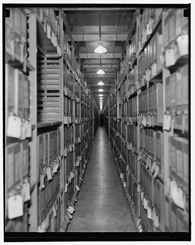 An aisle between tall shelves of boxed records at the National Archives in Washington, D.C.